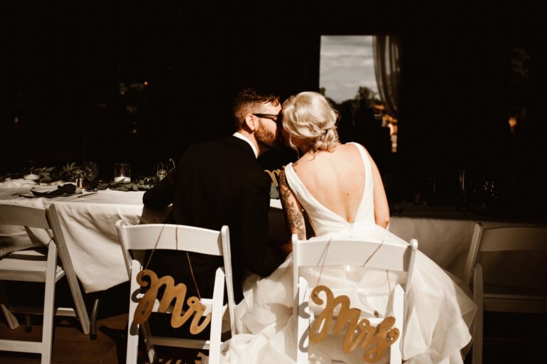 Bride and groom kissing during reception at Maple Meadows Farm.