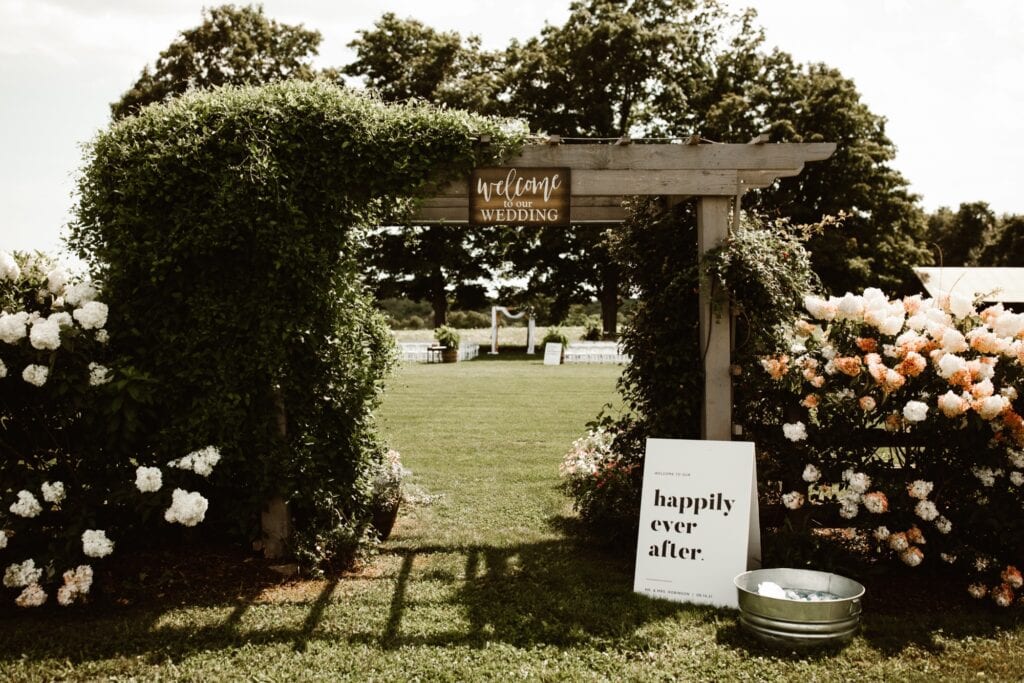 Maple Meadows outdoor wedding ceremony site framed by flowers and signs.