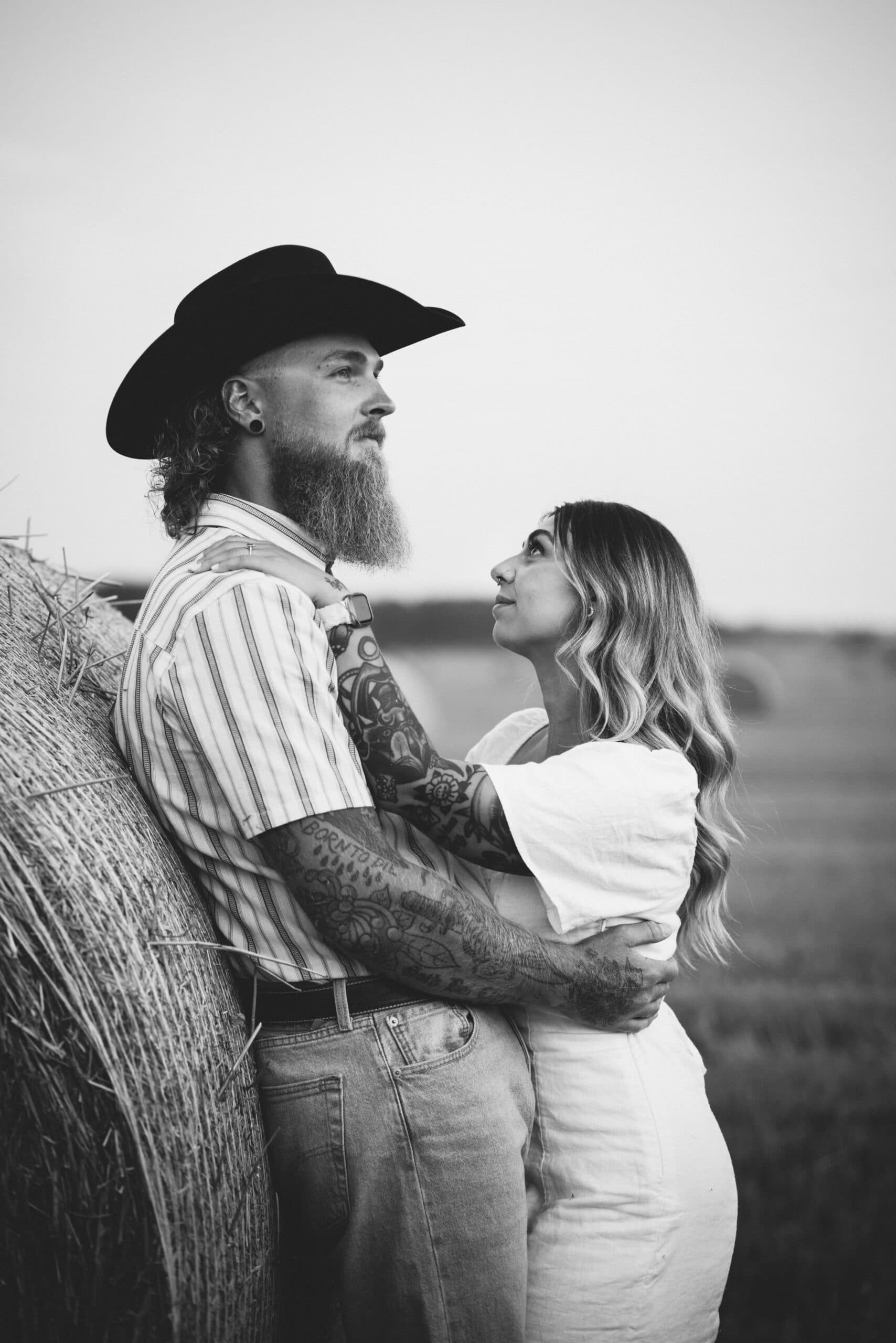 black and white tattooed couple at dusk staring off into the distance