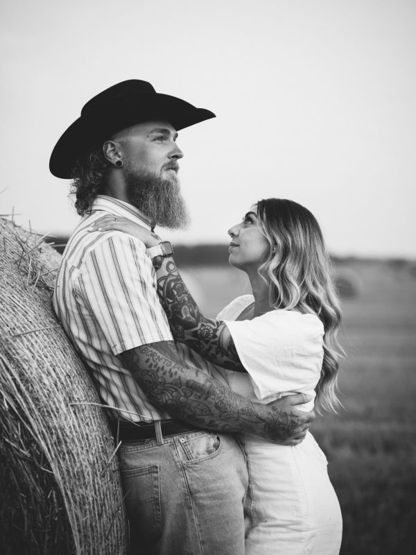 black and white tattooed couple at dusk staring off into the distance