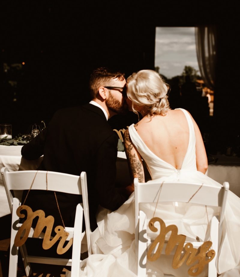 Bride and groom kissing during reception at Maple Meadows Farm.