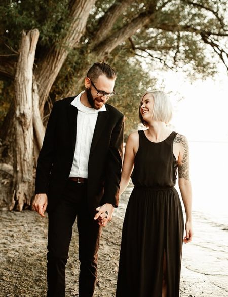 finely dressed man and woman walking along the beach at post dalhousie