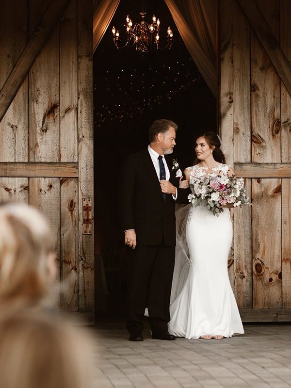 father and daughter coming up the aisle at Stone Estates wedding